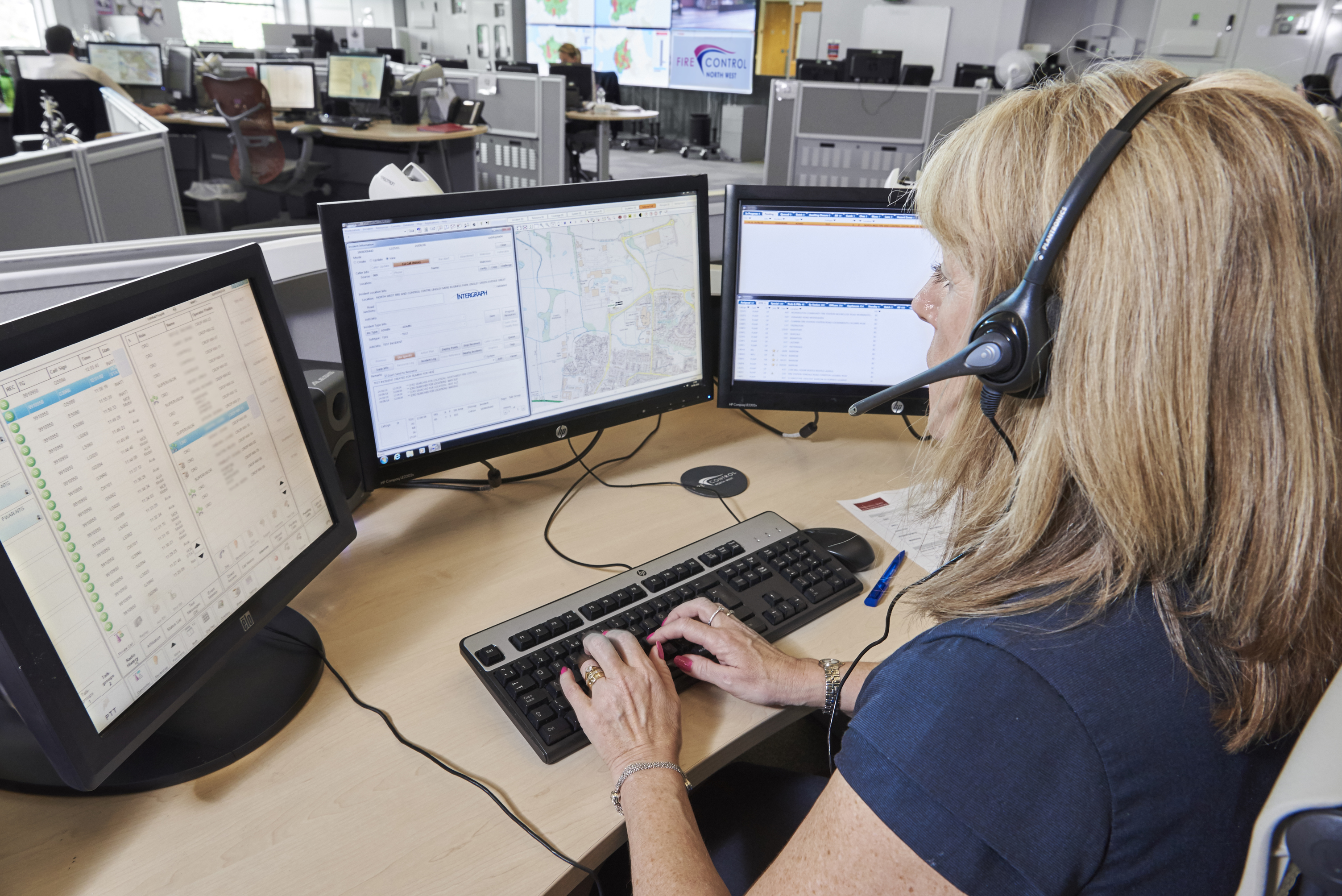 Image of a control room operator sat at her desk with control screens in front of her