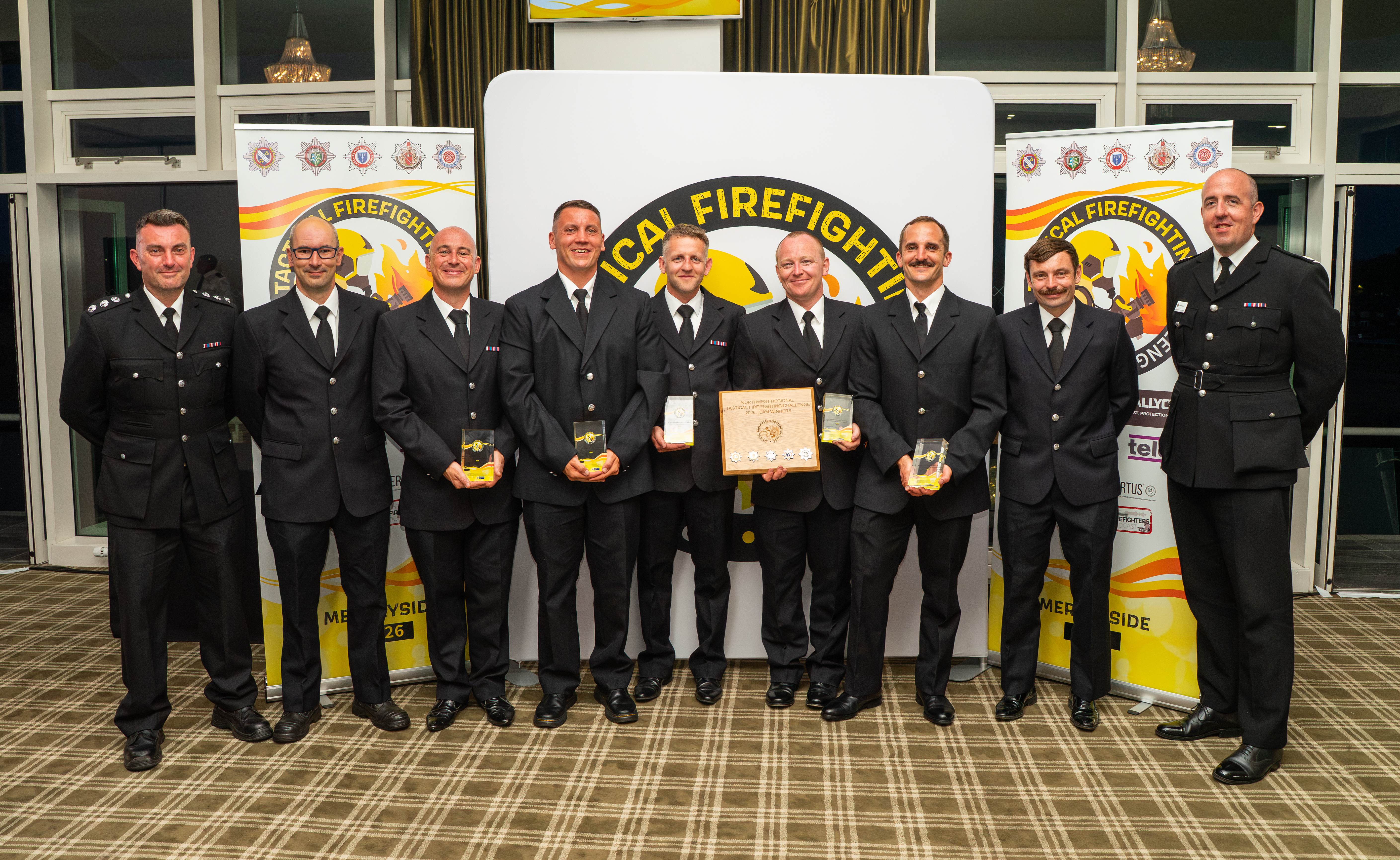 A team of firefighters and officers pose with their prize