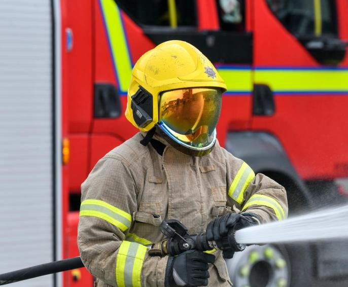 a firefighter spraying water