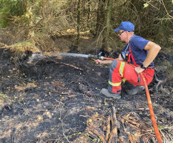 A firefighter working to put out a wildfire