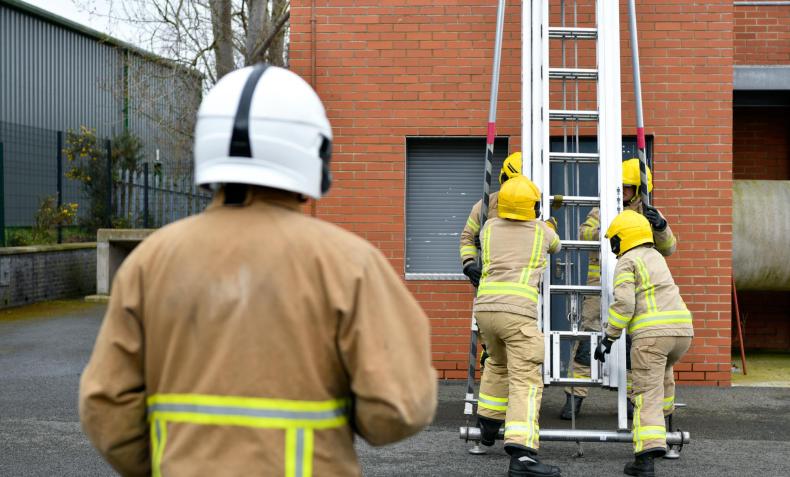 Firefighters taking part in ladder drills