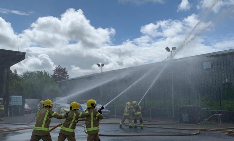 Firefighters taking part in hose drills