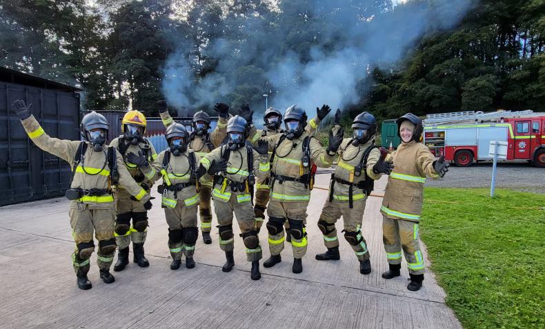 A photo of firefighters wearing BA celebrating after completing training
