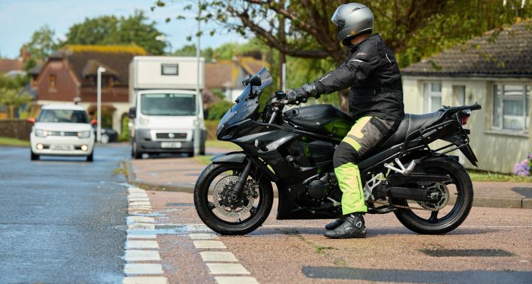 A motorcyclist at a junction waiting to pull out