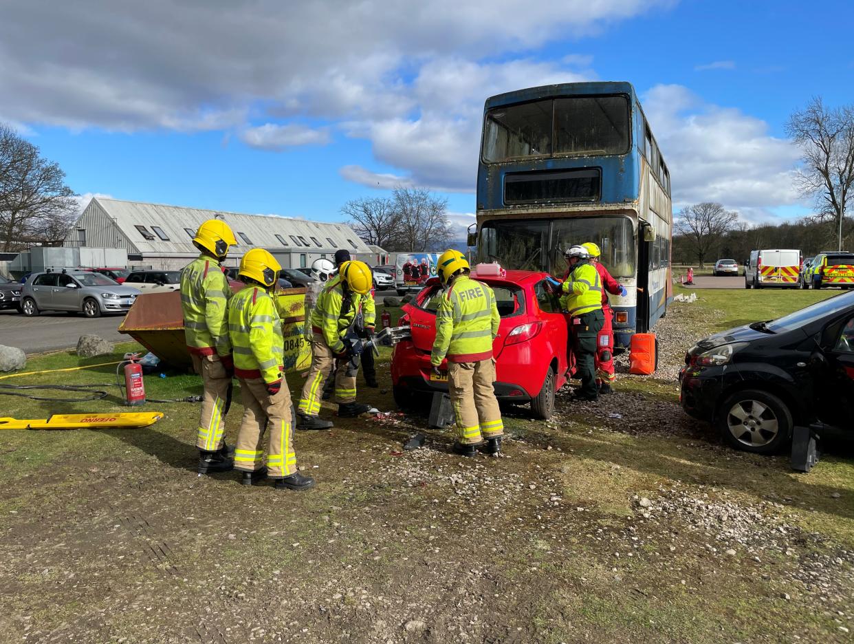 A group of firefighters try to gain access to a vehicle