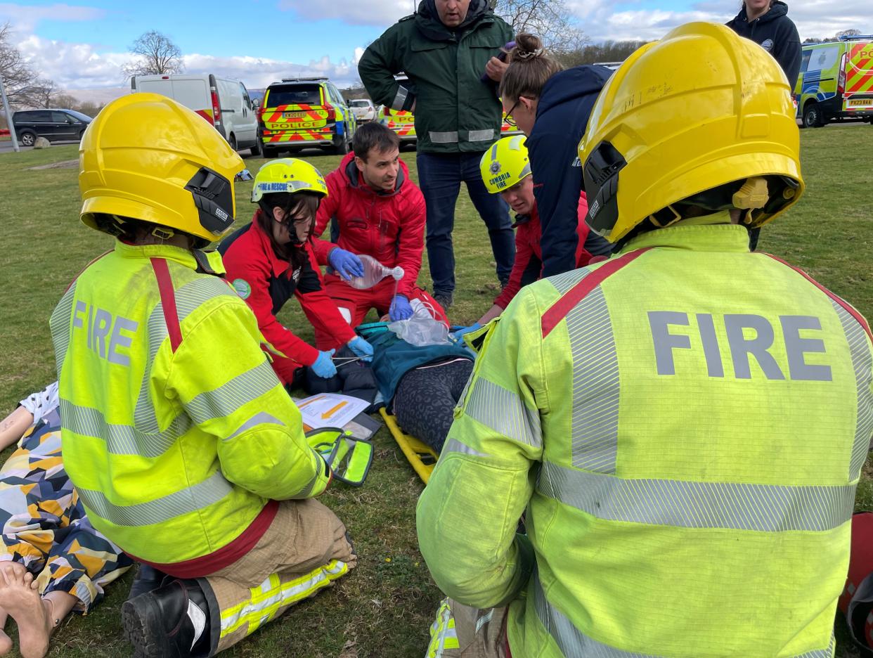 Two firefighters work with partner agencies during a training exercise