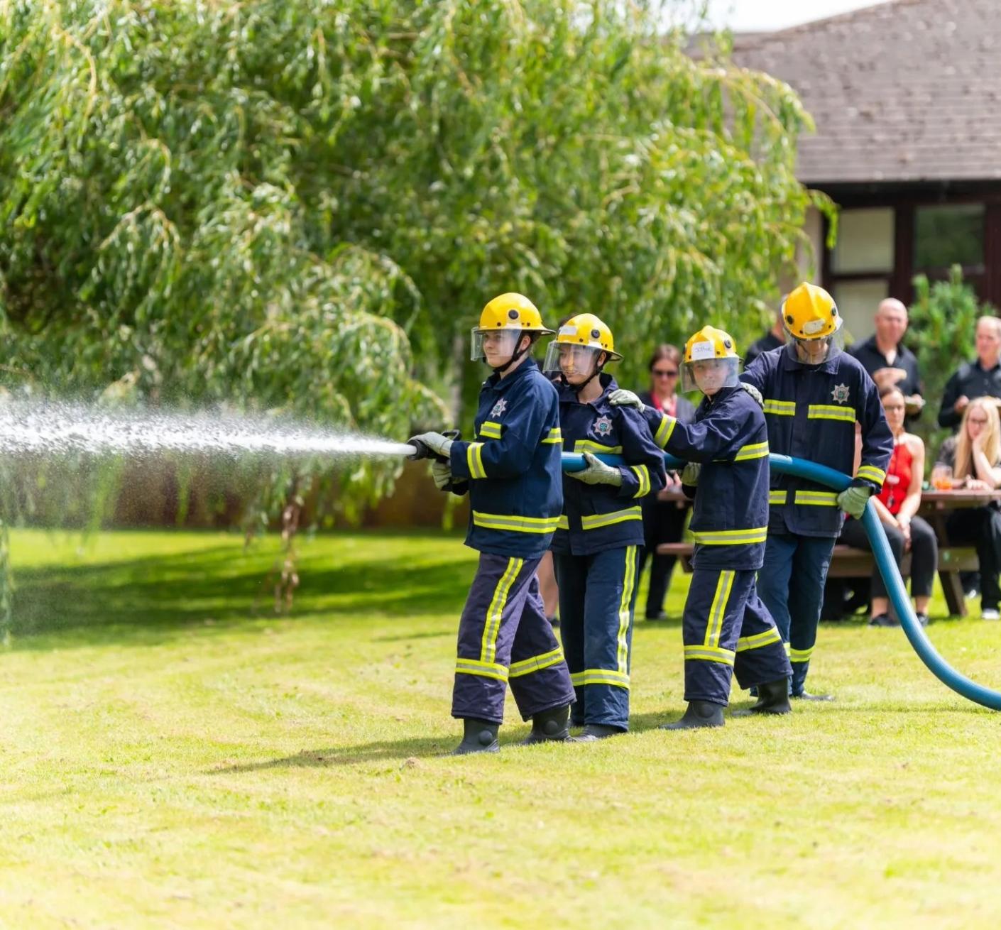 A crew of fire cadets give a live demo of using a hose reel jet