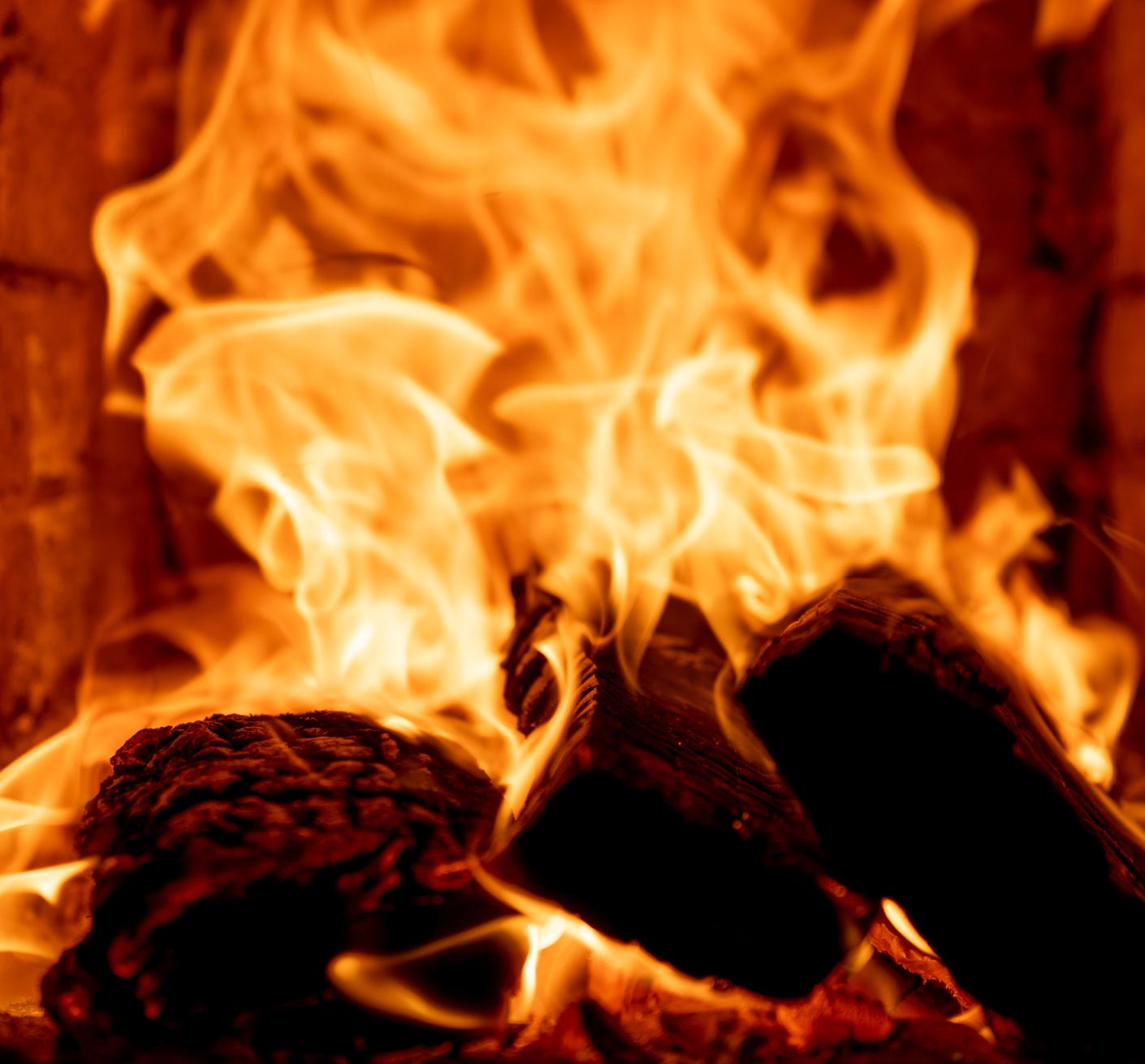 Wood burns in a fireplace