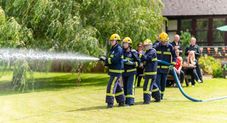 A crew of fire cadets give a live demo of using a hose reel jet