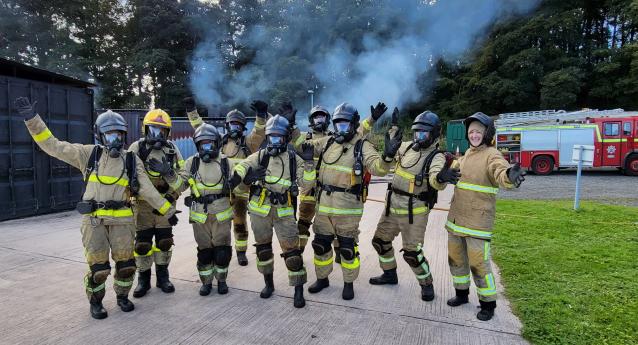 A photo of firefighters wearing BA celebrating after completing training