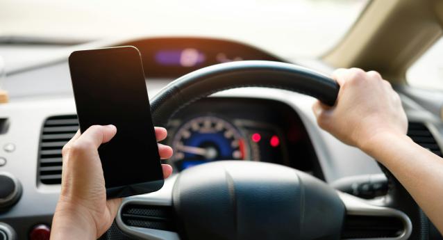 A motorist using a mobile phone while driving