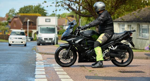 A motorcyclist at a junction waiting to pull out
